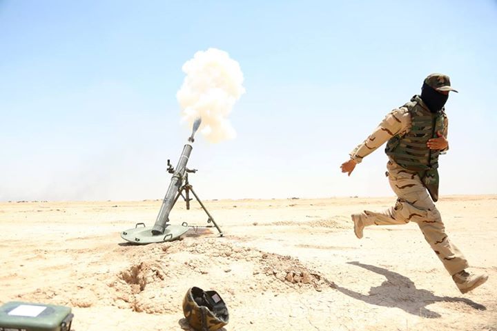 An Iraqi army soldier moves away from a 120 mm mortar he fires during training at Besmaya Range Complex, Iraq, June 16, 2015. - U.S. Army photo by Cpl. Nelson Rodriguez/CJTF-OIR Public Affairs