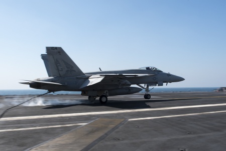 An F/A-18E Super Hornet, assigned to the “Pukin’ Dogs” of Strike Fighter Squadron (VFA) 143, lands on the flight deck of aircraft carrier USS Harry S. Truman (US Navy photo)