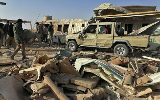 Fighters from the Kataeb Hezbollah, or Hezbollah Brigades militia, inspect the destruction at their headquarters in the aftermath of a U.S. airstrike in Qaim, Iraq, Monday, Dec. 30, 2019. The Iranian-backed militia said Monday that the death toll from U.S. military strikes in Iraq and Syria against its fighters has risen to 25, vowing to exact revenge for the "aggression of evil American ravens." (AP Photo)