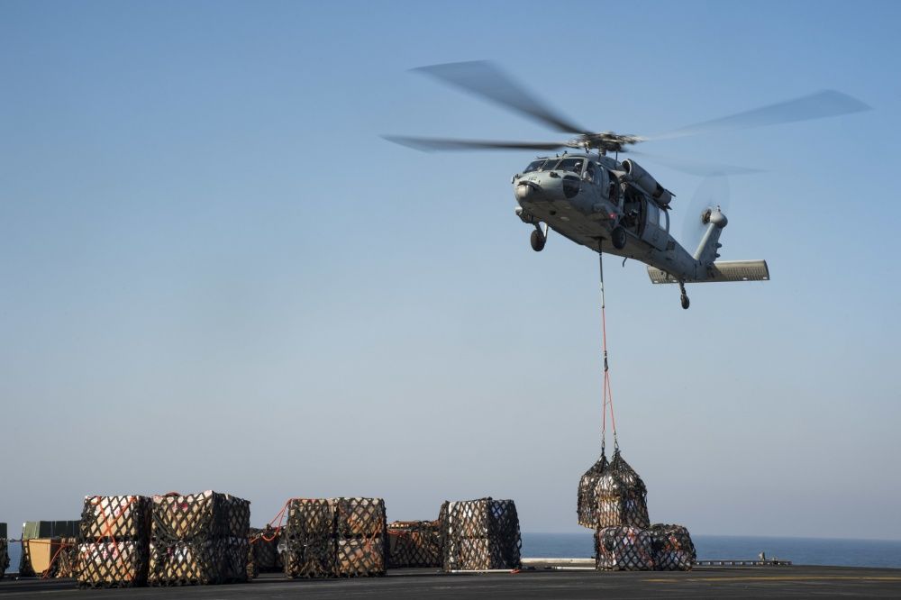 An MH-60S Sea Hawk helicopter places supplies on the flight deck of USS Dwight D. Eisenhower, Nov 11th (US Navy)