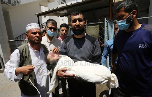 Body of the child identified as Ibrahim Al-Rantissi who was killed in strikes on Al Jeniya neighborhood on May 13, 2021. (Image posted by Anadolu Agency)