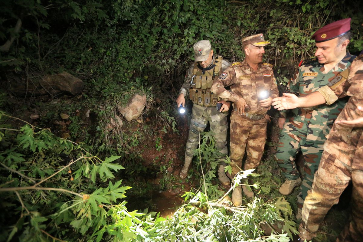 Security forces inspect the site of a Turkish attack on a mountain resort, according to Iraqi officials, in Iraq's northern province of Dohuk, Iraq, July 20, 2022. REUTERS/Ari Jalal