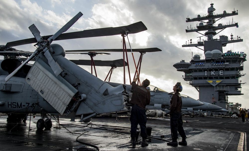 An MH-60R Sea Hawk helicopter is washed down on USS Dwight D. Eisenhower, Dec 2nd (US Navy)
