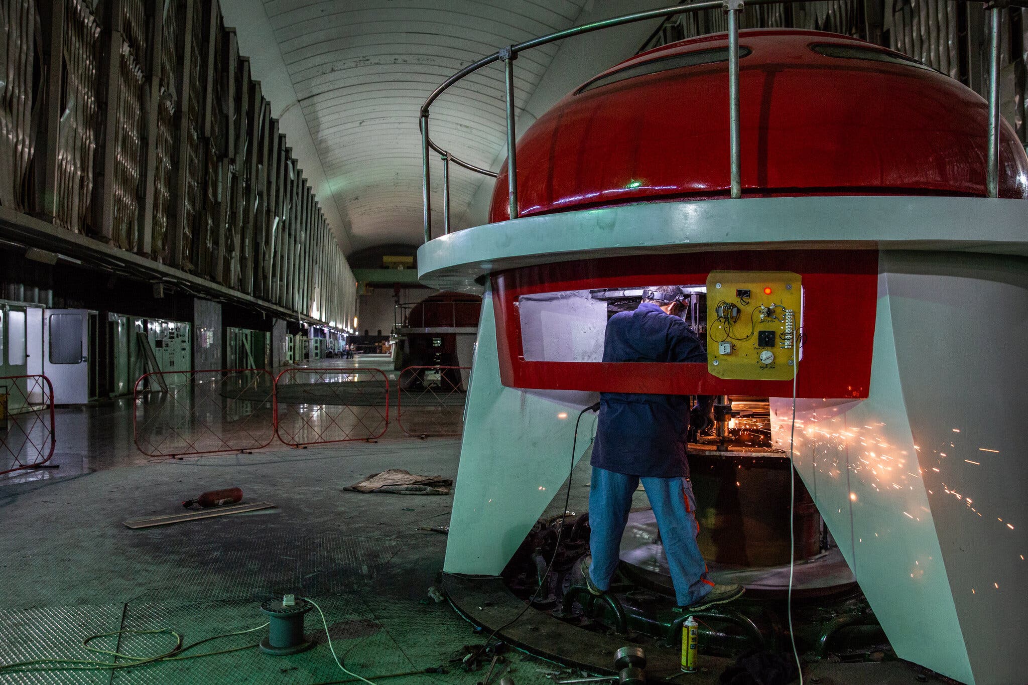 A worker in the dam’s turbine hall a year after the bombing.Credit...Ivor Prickett for The New York Times