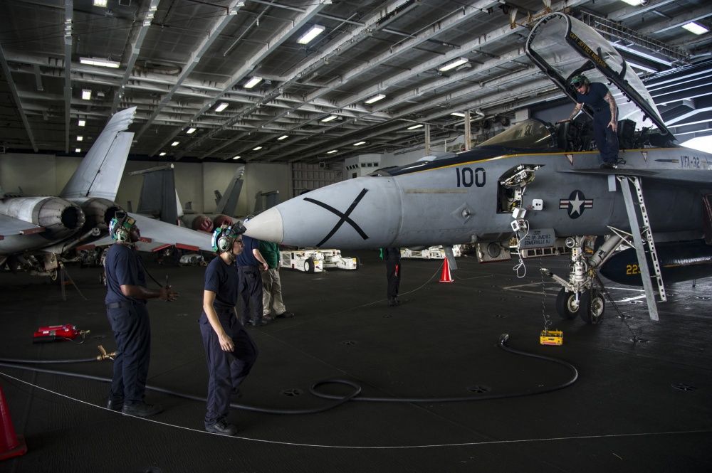 ailors cunduct low power turn test of an F/A-18F Super /hornet assigned to the Fighting Swordmen of Strike Fiighter Squadron of (VFA) 32 in the hangar bay of the aircraft carrier USS Dwight D. Eisenhower (US Navy)