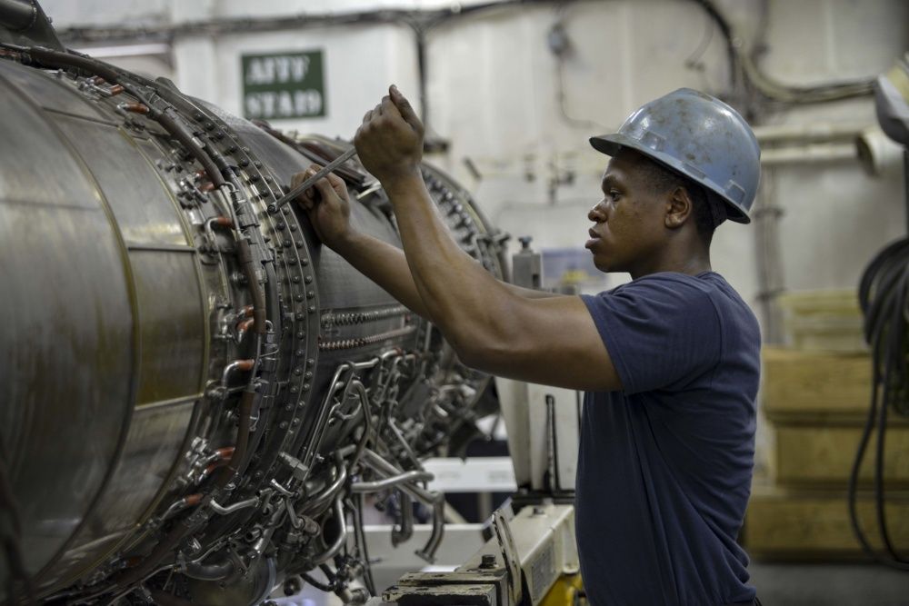 A Machinist's Mate prepares to separate an afterburner for maintenance in the jet shop of the aircraft carrier USS Dwight D. Eisenhower, Spet 29th (US Navy)
