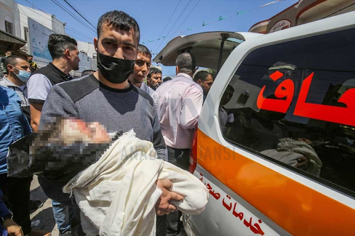 Body of the child identified as Ibrahim Al-Rantissi who was killed in strikes on Al Jeniya neighborhood on May 13, 2021. (Image posted by Anadolu Agency)