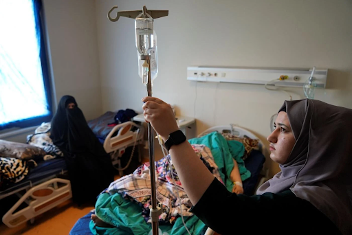 A nurse gives fluid therapy to Aseel Fadhel after leaving the operation room inside Zakho General Hospital (MEE/Azhar Al-Rubaie)