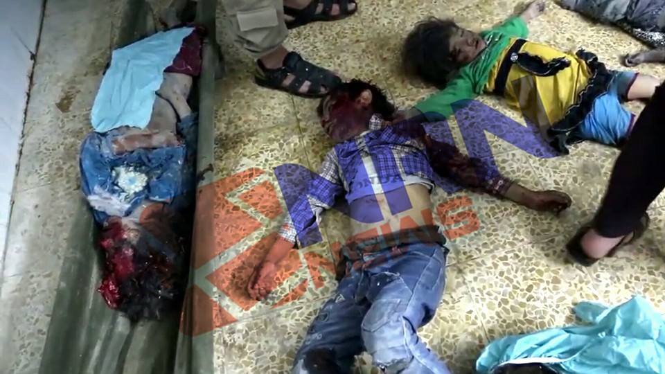 An image shows the children bodies on the floor that killed in an alleged coalition strike at Tal Afar, May 5th 2016 (via NRN)