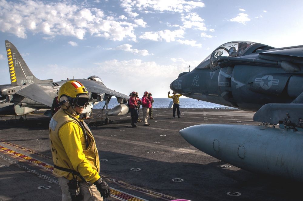 Sailors maneuver an AV-8B Harrier on the flight deck of USS Wasp, Sept 21st (US Navy)