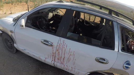 Blood of the victims on the car struck with a drone attack on the Ariha Al-Mastouma road on December 3, 2021. (Image posted by Syrian Civil Defense)