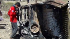 A Yemeni boy examines a destroyed vehicle in Shabwa, the target of a suspected US drone attack, April 21st (via CNN)