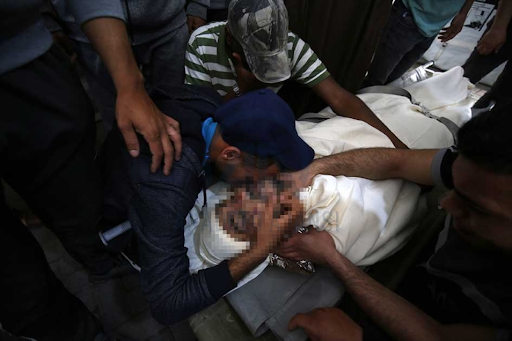 Body of the child identified as Ibrahim Al-Rantissi who was killed in strikes on Al Jeniya neighborhood on May 13, 2021. (Image posted by Anadolu Agency)