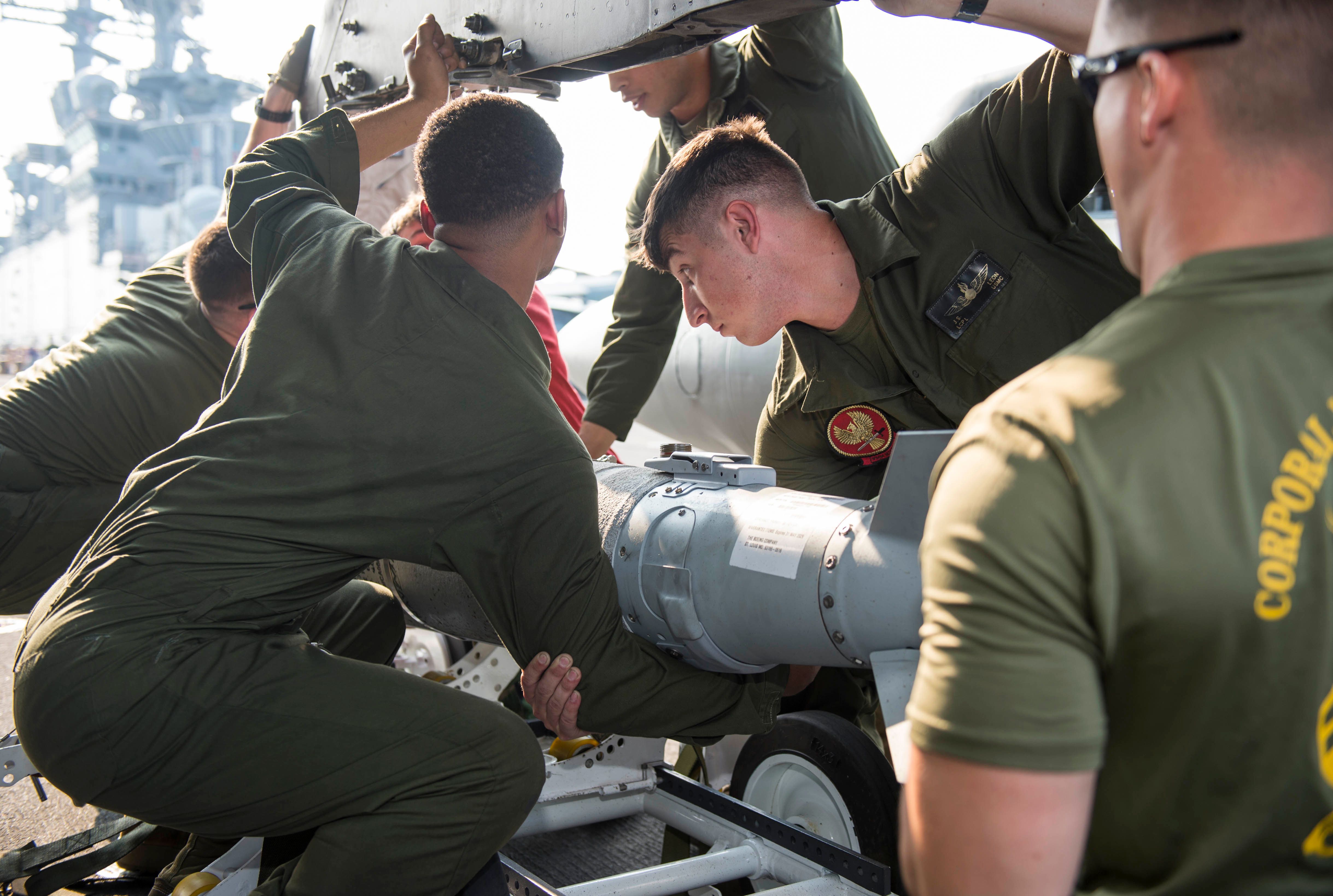 US Marines load ordnance onto an AV-8B Harrier on the amphibious assault ship USS Kearsarge, December 2nd 2015 (US Navy/Seaman Apprentice Dana D. Legg)