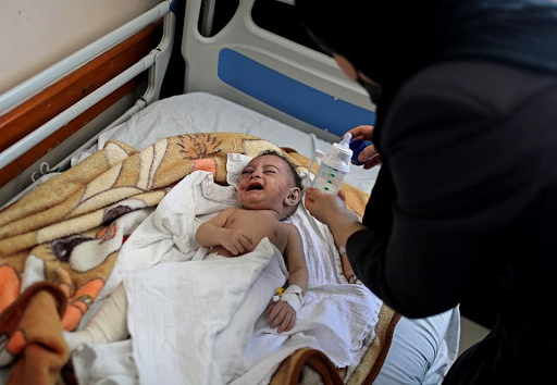 Image of baby Omar Al Hadidi, pulled from the rubble in critical condition and bring treated in a hospital following strikes on Al Shati camp on May 15th, 2021. (Image posted by Paltimes2015 via Facebook)