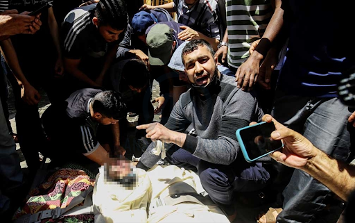 Body of the child identified as Ibrahim Al-Rantissi who was killed in strikes on Al Jeniya neighborhood on May 13, 2021. (Image posted by Anadolu Agency)
