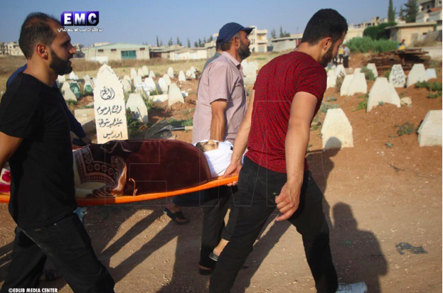 Syrian Civil Defense teams at the funeral of two of their colleagues who were killed in an alleged Russian double-tab airstrike on Khan Sheikhoun on June 26th (via Edlib Media Center).
