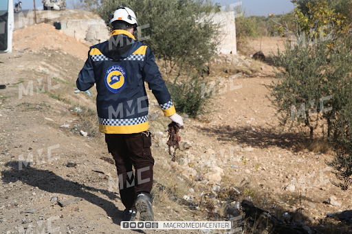 A White Helmet with remnants from the drone attack on the Ariha Al-Mastouma road on December 3, 2021. (Image posted by Macro Media Center)