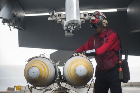 Aviation Ordnanceman 2nd Class Eduardo Felix, assigned to the “Fist of the Fleet” of Strike Fighter Squadron (VFA) 25, uploads ordnance to an F/A-18E Super Hornet on the flight deck of aircraft carrier USS Harry S. Truman (CVN 75) (via Navy Media Content Services)