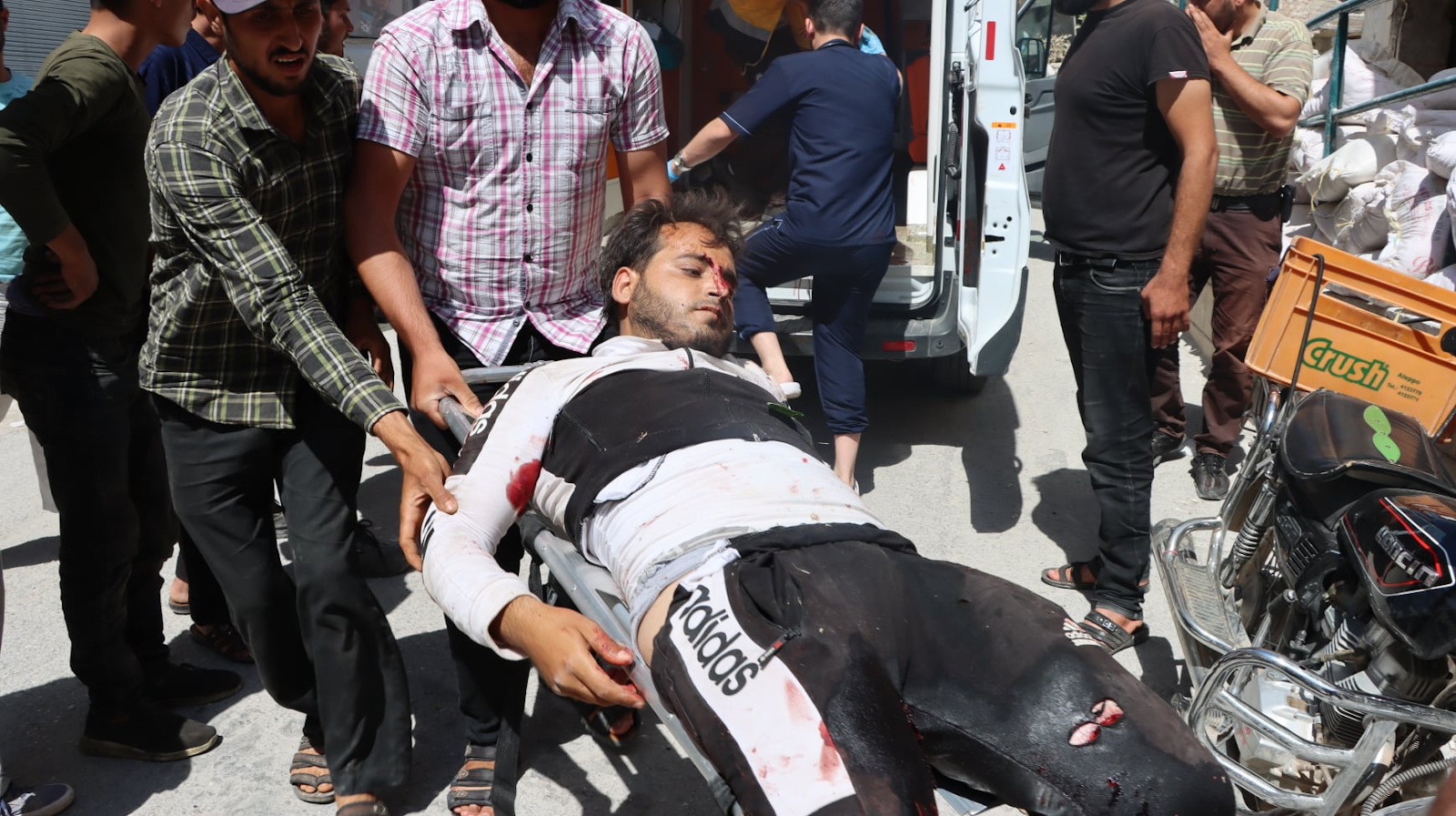 Civil Defense members treat the injured following a double strike on Sarja on July 17, 2021. (Image posted by Syrian Civil Defense)