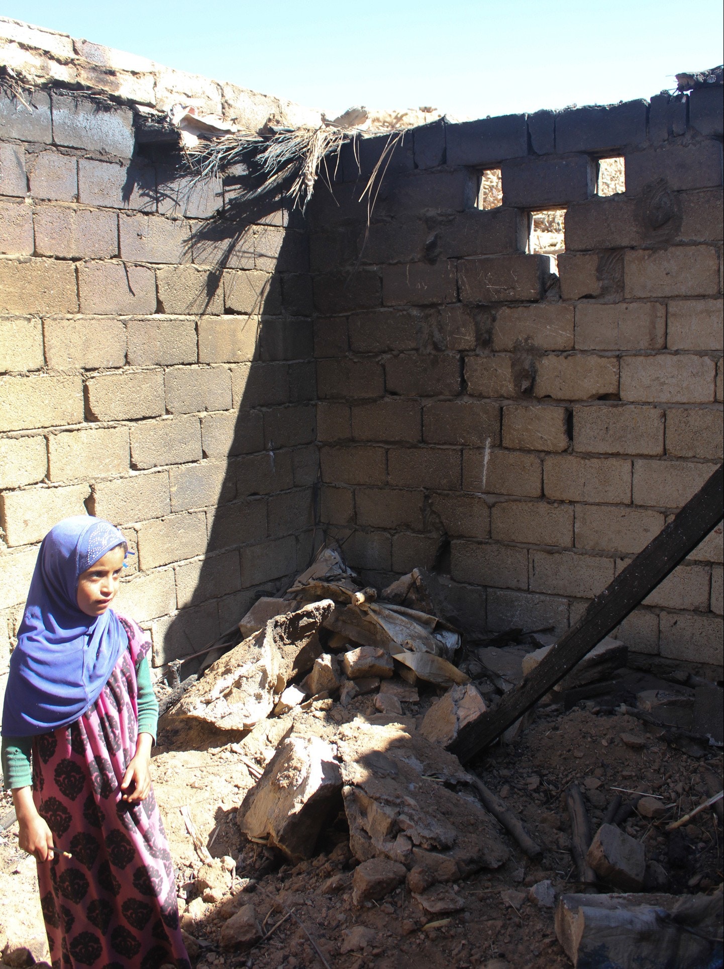 A girl in the remains of a building, reportedly destroyed during the January 29th 2017 raid (The Intercept, March 9th 2017)