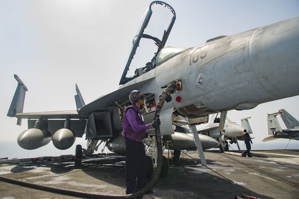 Airman Justin Saulbury, of Gainesville, Va., fuels an F/A-18F Super Hornet assigned to the Fighting Swordsmen of Strike Fighter Squadron (VFA) 32 on the flight deck of the aircraft carrier USS Dwight D. Eisenhower (US Navy)