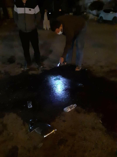 Civilians standing in the location where a mortar had landed earlier in Manshiya in Sabha and led to the death of a child and the injury of up to 30 others including children. (via Sabha News).
