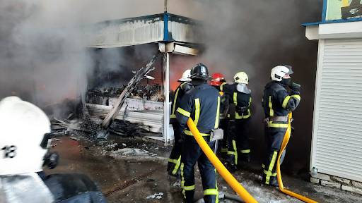 Rescue workers put out a fire at the market in the Heroiv Pratsi on March 16, 2022. (Image posted by DSNS via Telegram)