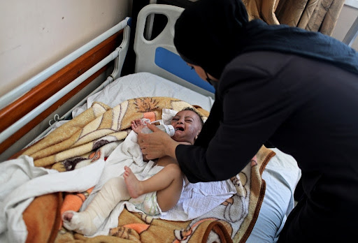 Image of baby Omar Al Hadidi, pulled from the rubble in critical condition and now in a leg cast following strikes on Al Shati camp on May 15th, 2021. (Image posted by @seedra29p)