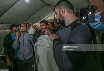Body of the child identified as Ibrahim Al-Rantissi who was killed in strikes on Al Jeniya neighborhood on May 13, 2021. (Image posted by Getty)