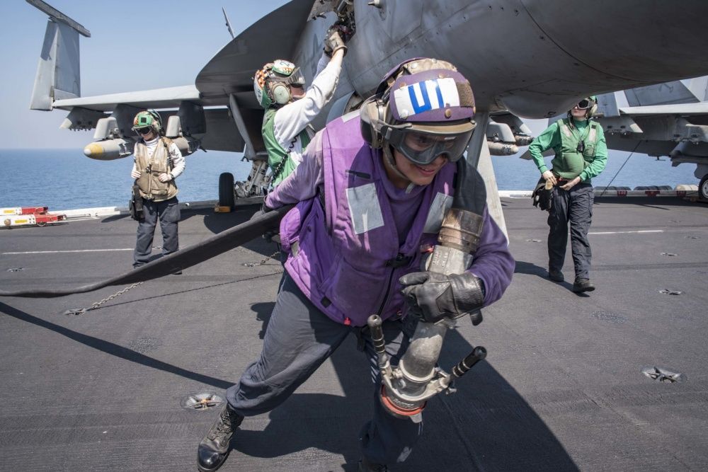 A refueling hose is brought onto the flight deck of the aircraft carrier USS Dwight D. Eisenhower , Oct 6th (US Navy)