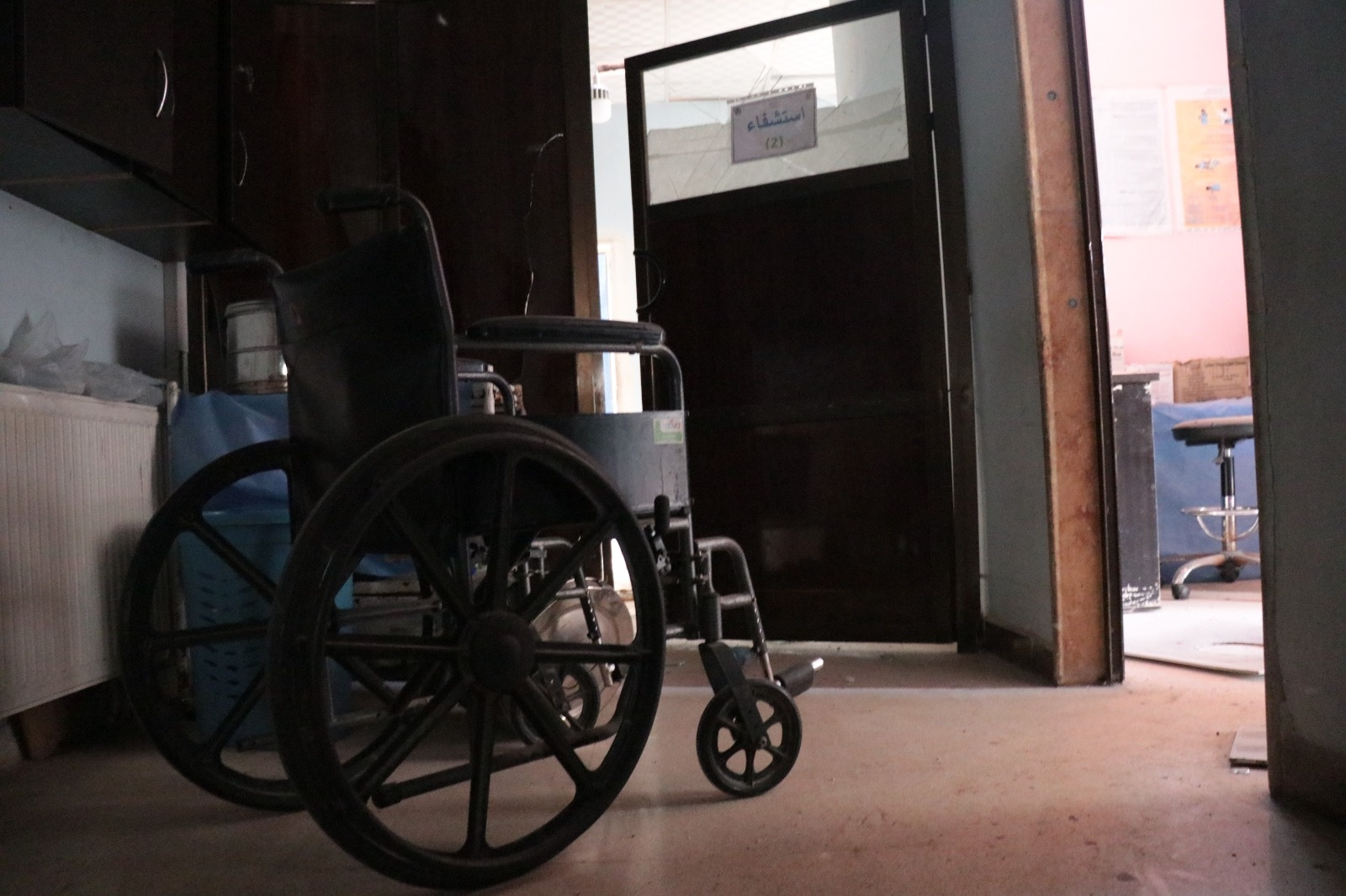 An image of a wheelchair in the destroyed Al-Shifaa hospital, which suffered damage from airstrikes on Afrin on June 12, 2021. (Image posted by Syrian Civil Defense)