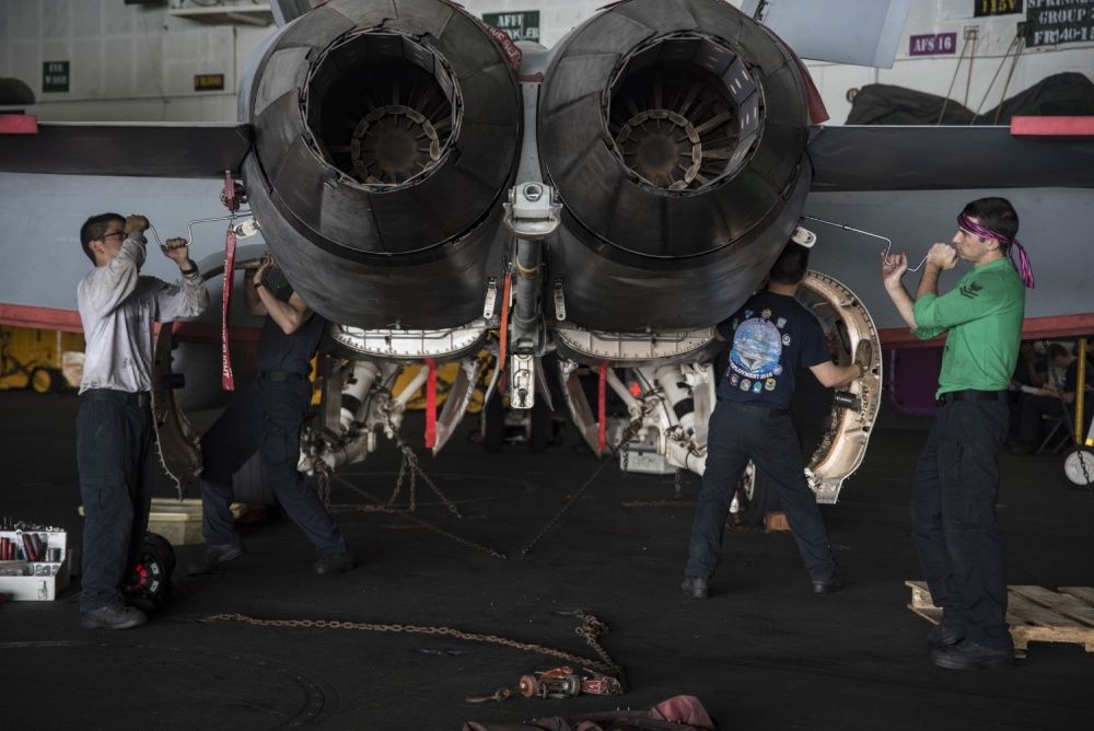 Maintenance on an F/A-18E Super Hornet in the hangar bay of the aircraft carrier USS Dwight D. Eisenhower (US Navy)
