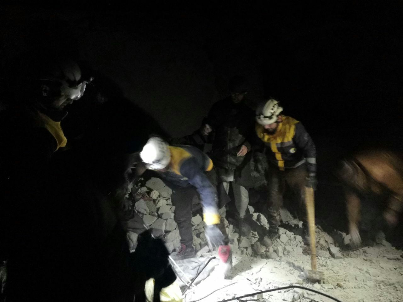 Syrian Civil Defence volunteers looking for victims and survivors underneath the rubble after alleged Russian airstrikes on the village of Arinba on January 23rd, 2020 (via @ShahbaPress).