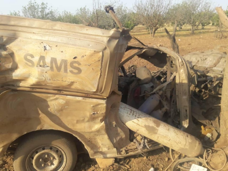 Image Caption Translation: "Fadi Al-Omar and Mohammad Hosni Mashnen, who sacrificed their lives today for Syria, join our colleagues in the Hama Ambulance System (SAMS) in mourning the martyr heroes, who were brutally killed by a direct Russian air strike targeting ambulances while they were in the medical point in the southern countryside of Idlib this morning" (via Justice Organisation)