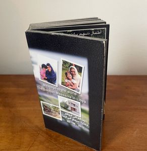 An image of a book produced by the Hamedi family entitled "Message to the world - The Sorman Massacre in Libya"