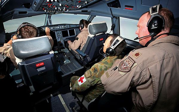 United States Air Force Flight Surgeon, Major Russell Tontz (right), and RAAF Aviation Medical Officer, Flight Lieutenant Dan Gardon (centre), observe the crew on a Royal Australian Air Force (RAAF) KC-30A Multi-Role Tanker Transport aircraft as they conduct an air-to-air refuellng mission on coalition operations above Iraq (Aus MoD)