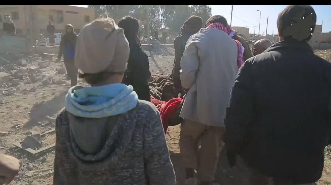 Rescuers remove a casualty from a suspected Coalition airstrike (via Free Deir Ezzor Radio)