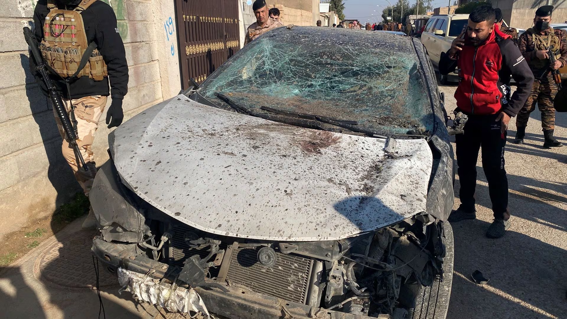 Security forces inspect a damaged car at the site of a U.S. airstrike in al-Qaim, Iraq February 3, 2024. REUTERS/Stringer