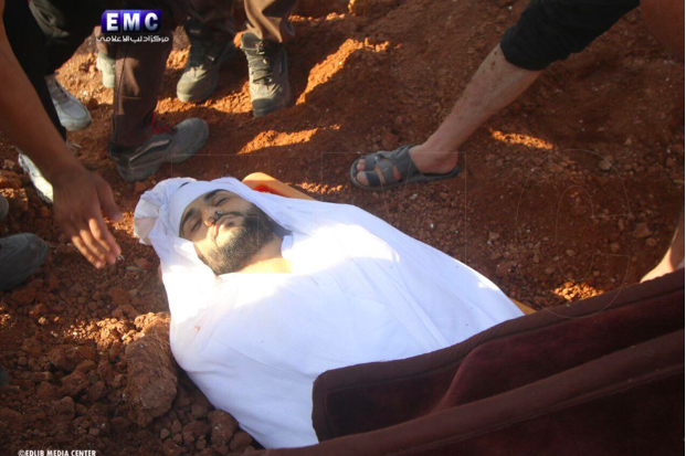 Omar, wrapped in a white sheet for his funeral after he was killed in an alleged Russian double-tab airstrike on Khan Sheikhoun on June 26th (via Edlib Media Center).