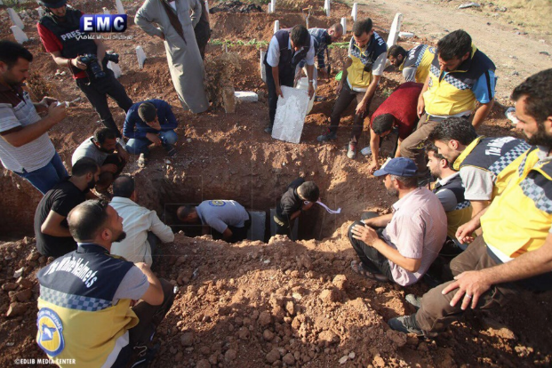 Syrian Civil Defense volunteers bury their colleagues killed in an alleged 'double-tap' strike by Russian forces, June 2019. Image via Idlib Media Centre.