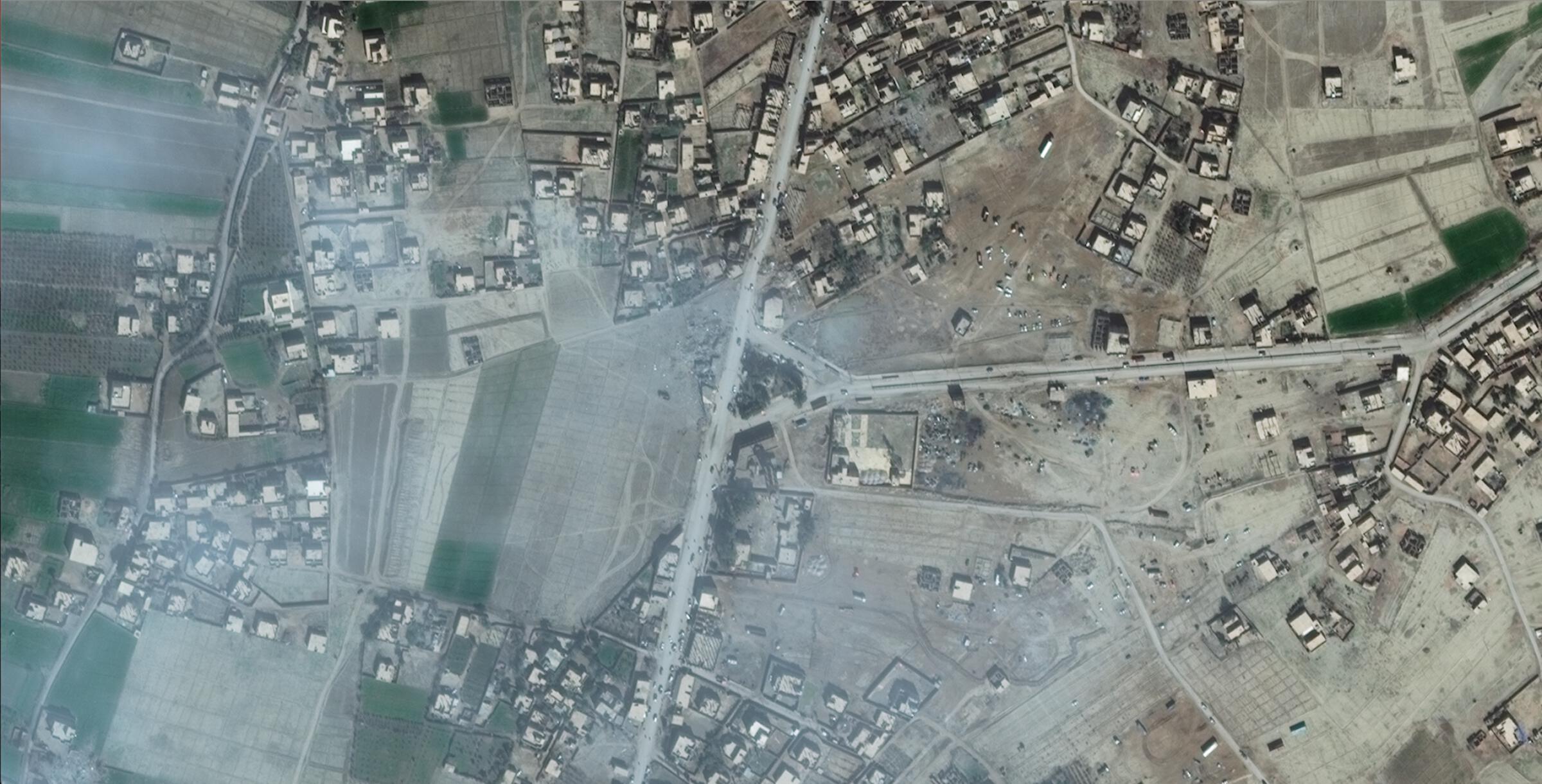 Imagery shows a destroyed building, presumed to be Al Boomsir complex, in the center of the image along the vertically running main road left of the triangular junction. (Via Bellingcat)