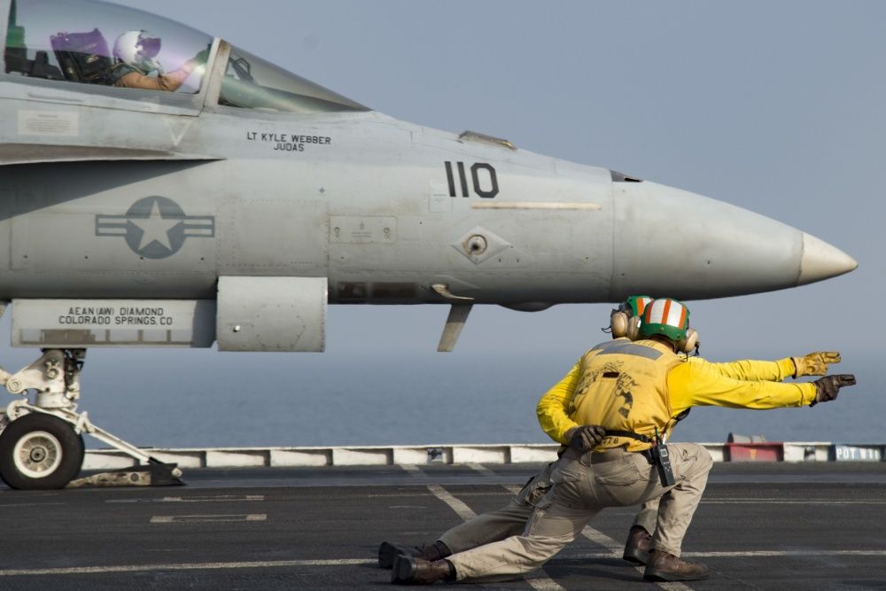 An F/A-18F Super Hornet assigned to the Fighting Swordsmen of Strike Fighter Squadron (VFA) 32 launches from the flight deck of the aircraft carrier USS Dwight D. Eisenhower (US Navy)