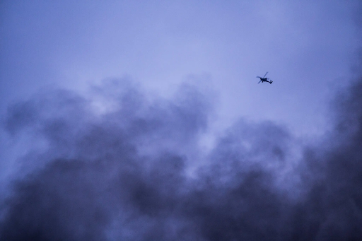 An American attack helicopter flies over Hasaka on Monday. The United States has been conducting airstrikes there for four days.Credit...Baderkhan Ahmad/Associated Press