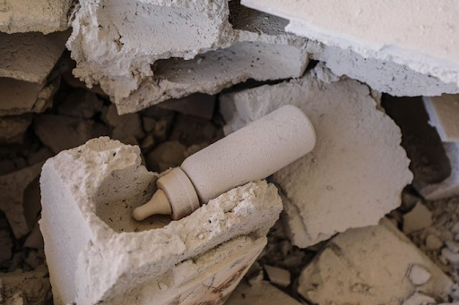 A bottle belonging to one of the children killed in alleged Russian strikes on Kansafra on August 20, 2021. (Image posted by @thawrat111)