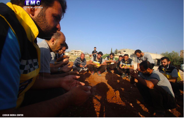 Syrian Civil Defense teams at the funeral of two of their colleagues who were killed in an alleged Russian double-tab airstrike on Khan Sheikhoun on June 26th (via Edlib Media Center).