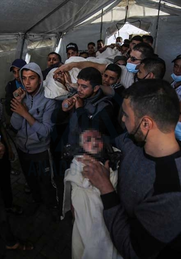 Body of the child identified as Ibrahim Al-Rantissi who was killed in strikes on Al Jeniya neighborhood on May 13, 2021. (Image posted by Anadolu Agency)
