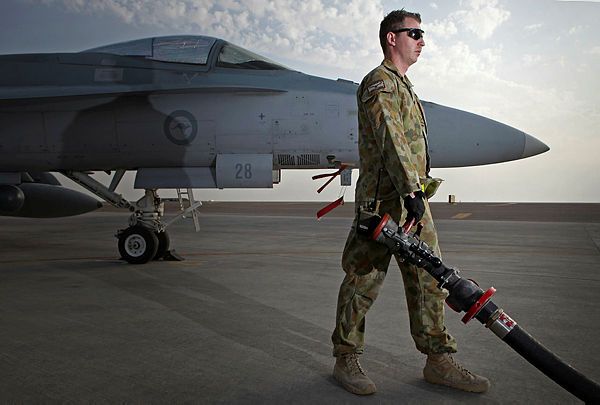 A Royal Australian Air Force Aircraft Refueller prepares to refuel an Australian F/A-18A Hornet fighter aircraft prior to conducting a sortie over the Middle East (Aus MoD)