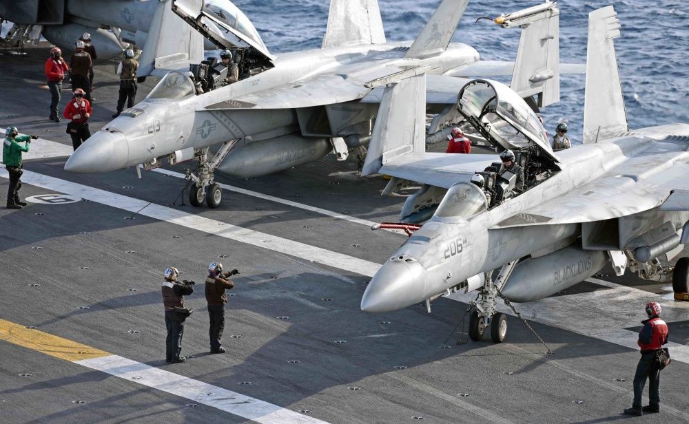 Sailors assigned to the aircraft carrier USS George H.W. Bush signal pilots in preparation for flight operations, march 8th (US Navy)