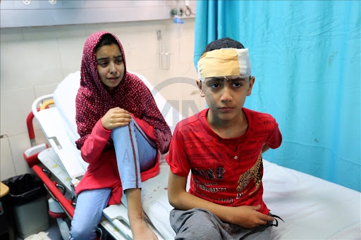 Kids injured in Israeli attack carried out to home of Palestinian Abu Khatab Familiy living in Al-Shati Camp in Gaza Strip, receive treatment at Shifa Hospital on May 15, 2021 (Image posted by Anadolu Agency)